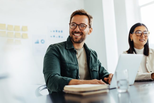Happy,Business,Man,Listening,To,A,Discussion,In,An,Office