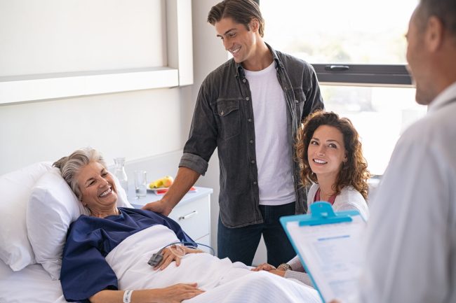 Happy,Senior,Woman,Lying,On,Hospital,Bed,With,Lovely,Son