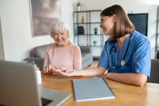 Woman,Using,Computer,To,Offer,Professional,Assistance,To,Retired,Patient